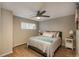 Bedroom featuring a ceiling fan, hardwood floors, a radiator, and two large windows at 5000 S Chester St, Greenwood Village, CO 80111