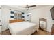 Comfortable bedroom with modern decor, wooden headboard, hardwood floors, and ample natural light at 5000 S Chester St, Greenwood Village, CO 80111