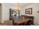 Dining room featuring an elegant chandelier, dining table with seating, and access to the outdoors at 5000 S Chester St, Greenwood Village, CO 80111