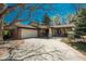 Charming single-story home with brick accents, mature trees, and a spacious driveway and entry at 5000 S Chester St, Greenwood Village, CO 80111