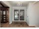 Elegant foyer with wood floors, a chandelier, and shuttered doors leading to the outside at 5000 S Chester St, Greenwood Village, CO 80111