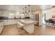 Bright kitchen with white cabinets, a large island, stainless steel appliances, and hardwood floors at 5000 S Chester St, Greenwood Village, CO 80111
