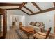 Comfortable living room with exposed beams, hardwood floors, and plenty of seating at 5000 S Chester St, Greenwood Village, CO 80111