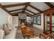 Inviting living room with vaulted ceilings, exposed beams, stone fireplace, and lots of natural light at 5000 S Chester St, Greenwood Village, CO 80111