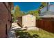 Exterior view of a well-maintained storage shed beside the home, providing extra space and organization at 5000 S Chester St, Greenwood Village, CO 80111
