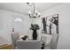 Charming dining area with glass table and modern light fixture at 9647 Pelon Dr, Northglenn, CO 80260