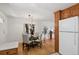 Dining area with glass-top table and view into the kitchen at 9647 Pelon Dr, Northglenn, CO 80260