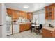 Well-equipped kitchen featuring wood cabinetry and modern appliances at 9647 Pelon Dr, Northglenn, CO 80260