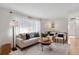 Light-filled living room with comfortable seating and large windows at 9647 Pelon Dr, Northglenn, CO 80260