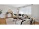 Living room with hardwood floors, a neutral color palette, and ample natural light at 9647 Pelon Dr, Northglenn, CO 80260