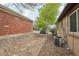 This gravel-covered backyard has rock landscaping, and a central air conditioner unit at 55 Emerald St, Broomfield, CO 80020
