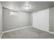 This is a neutral bedroom with gray carpet, gray walls, and a window for soft natural light at 55 Emerald St, Broomfield, CO 80020