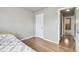 Bright bedroom with hardwood floors, and access to an adjacent hallway and bathroom at 55 Emerald St, Broomfield, CO 80020