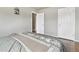 Bedroom with hardwood floors, bed with a patterned blanket, and a closet at 55 Emerald St, Broomfield, CO 80020
