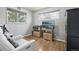 A cozy bedroom features hardwood floors, two windows, and a comfortable white chair at 55 Emerald St, Broomfield, CO 80020