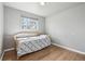 Bedroom with a light-colored daybed, hardwood floors, and a bright window at 55 Emerald St, Broomfield, CO 80020
