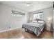 Bright bedroom with hardwood floors, windows and two side tables at 55 Emerald St, Broomfield, CO 80020