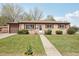 Charming single-story home with a well-maintained front yard and inviting walkway at 55 Emerald St, Broomfield, CO 80020