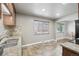 Kitchen featuring a stainless steel sink, tile backsplash, and view into the dining room at 55 Emerald St, Broomfield, CO 80020