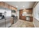 Modern kitchen with stainless steel appliances and wood cabinetry at 55 Emerald St, Broomfield, CO 80020