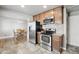 Open kitchen with stainless steel appliances, granite countertops, and easy access to dining area at 55 Emerald St, Broomfield, CO 80020