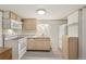 An eat-in kitchen area, with white appliances and light wooden cabinets, provides a cozy area to cook at 55 Emerald St, Broomfield, CO 80020