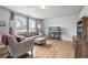 Inviting living room with hardwood floors and large windows allowing ample natural light at 55 Emerald St, Broomfield, CO 80020