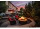 Inviting backyard with a stone fire pit, outdoor seating, and a built-in bar, perfect for entertaining at 12035 Fontberry St, Parker, CO 80134