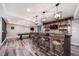 Finished basement boasts a custom bar with rustic accents, pool table, and media area at 12035 Fontberry St, Parker, CO 80134