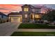 Charming two-story home with a well-manicured lawn, a stone facade, and a welcoming covered front porch at 12035 Fontberry St, Parker, CO 80134