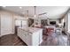 Open kitchen view with island, stainless steel appliances, and seamless flow to dining and living spaces at 12035 Fontberry St, Parker, CO 80134