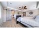 Relaxing bedroom with a sliding barn door leading to the bathroom, neutral tones, and ceiling fan at 12035 Fontberry St, Parker, CO 80134