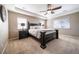 Spacious main bedroom featuring a tray ceiling, ceiling fan, and large windows for natural light at 12035 Fontberry St, Parker, CO 80134