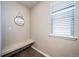 Cozy mud room with a window, bench, and decorative 'blessed' sign for a welcoming touch at 12035 Fontberry St, Parker, CO 80134