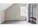 Neutral bedroom features gray carpet, natural light from the window, and a closet with hanging racks and shelving at 2565 Pierce St, Lakewood, CO 80214