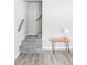 Entryway with gray stairs and modern side table with lamp at 2565 Pierce St, Lakewood, CO 80214