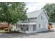 Charming gray two-story home featuring a covered front porch and mature landscaping at 2565 Pierce St, Lakewood, CO 80214