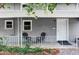 Inviting covered porch with seating and decorative details at 2565 Pierce St, Lakewood, CO 80214