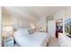 A well-lit bedroom showcases soft decor and bedding complemented by an adjacent kitchen area and a modern television at 601 W 11Th Ave # 1109, Denver, CO 80204