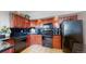 Efficient kitchen features dark wood cabinets, modern black appliances, and ample counter space at 601 W 11Th Ave # 1109, Denver, CO 80204