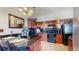 Functional kitchen featuring dark wood cabinets, black appliances, and tile flooring at 601 W 11Th Ave # 1109, Denver, CO 80204