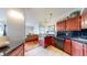 Open kitchen area with dark wood cabinetry and stainless steel appliances flowing into the living area at 601 W 11Th Ave # 1109, Denver, CO 80204