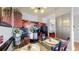 Charming kitchen featuring dark wood cabinets, black countertops, and a dining area with place settings at 601 W 11Th Ave # 1109, Denver, CO 80204