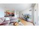 Open-concept living area with hardwood floors, comfortable sofa and a kitchen with dark wood cabinetry at 601 W 11Th Ave # 1109, Denver, CO 80204
