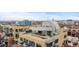 An aerial view of city buildings with rooftop decks and views at 1499 Blake St # 3O, Denver, CO 80202