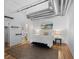 Stylish bedroom features a neutral color scheme, duct work, and hardwood floors at 1499 Blake St # 3O, Denver, CO 80202