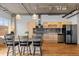 Modern kitchen with stainless steel appliances, custom cabinetry, and an island with bar seating at 1499 Blake St # 3O, Denver, CO 80202