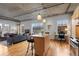 Bright living space with modern kitchen island, hardwood floors, and exposed ceiling elements at 1499 Blake St # 3O, Denver, CO 80202