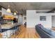 Bright living space with kitchen island and seating, hardwood floors, and exposed ceiling elements at 1499 Blake St # 3O, Denver, CO 80202