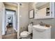 Bathroom with white vanity, artwork, and view to a bedroom at 2920 Ivy St, Denver, CO 80207